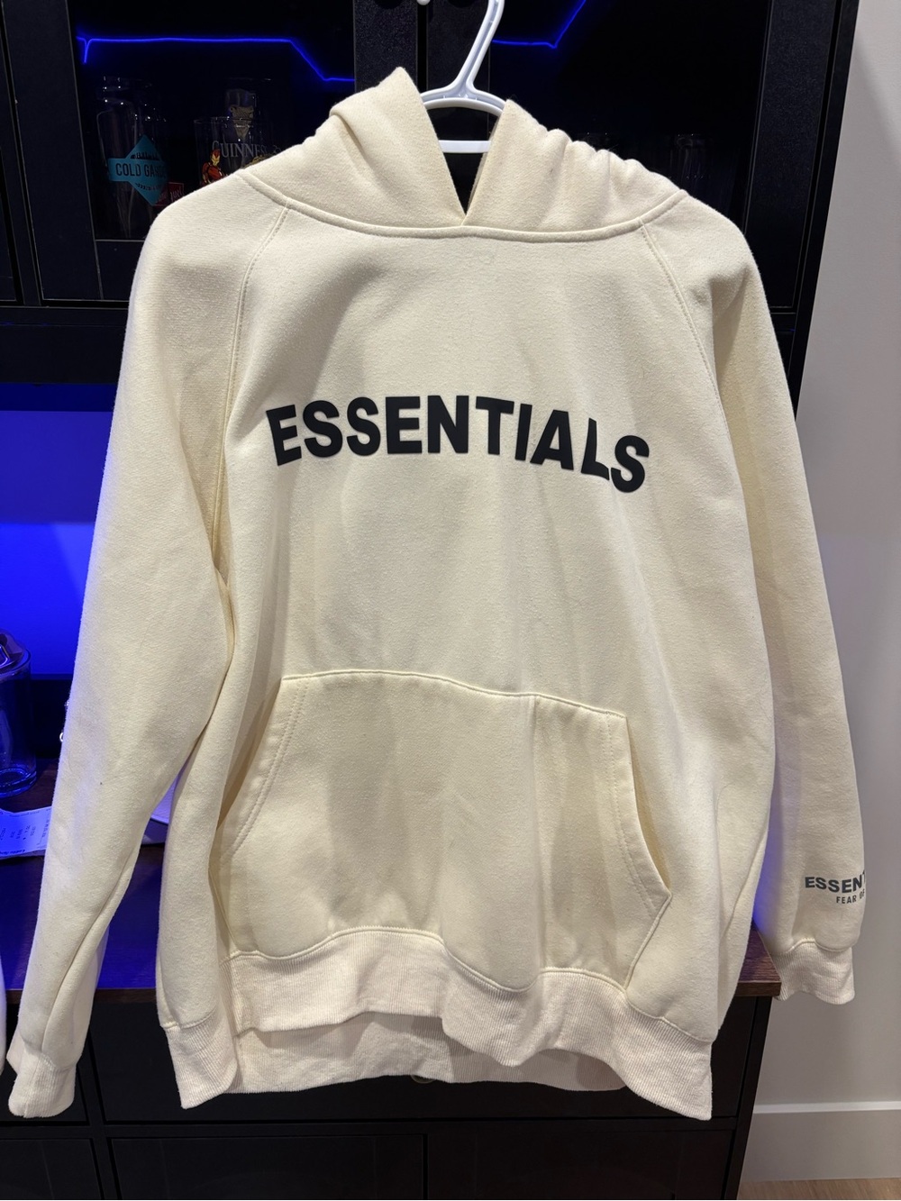 Fear of God ESSENTIALS Cream Hoodie with Black Logo